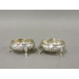 A pair of George III silver salts, initials possibly W C, London 1774, repoussé with flowers on