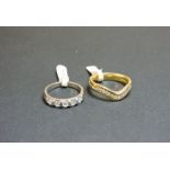 A 9ct white gold diamond set band ring, one diamond loose, an 18ct yellow gold diamond set wave