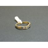 A 9ct gold sapphire and diamond half wishbone ring