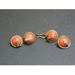A set of four gold Victorian coral buttons, each with a coiled snake