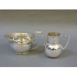 Two silver cream jugs, Berthold Muller, import marks Chester 1900, decorated with a pastoral