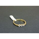 An 18ct yellow gold three stone diamond ring