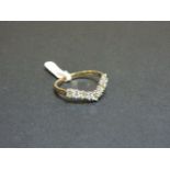 A 9ct yellow and white gold peridot and diamond half wishbone ring