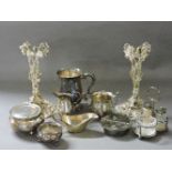 A silver cream jug, a sugar bowl, and a collection of silver plated items, including two stands