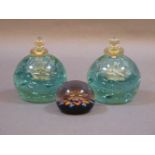 A pair of Stourbridge green glass paperweights and inkwells, with clear glass stoppers, and a