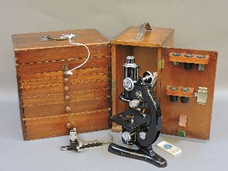 A dental cabinet with contents, and a cased microscope