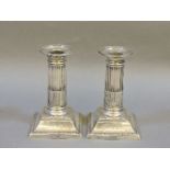 A pair of weighted silver candlesticks, Sheffield 1908, inscribed, 13cm high