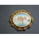 An Indian gilt metal hand painted miniature on ivory brooch