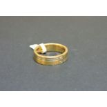 An 18ct yellow and white gold satin finished band ring, set with two brilliant cut diamonds