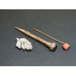 A gold slide action pencil, with a bloodstone set end, a paste brooch, and a stick pin