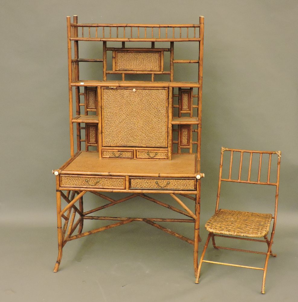 A bamboo and wicker desk, by E Murio for Pied à Terre, labelled, with shelves flanking a hinged