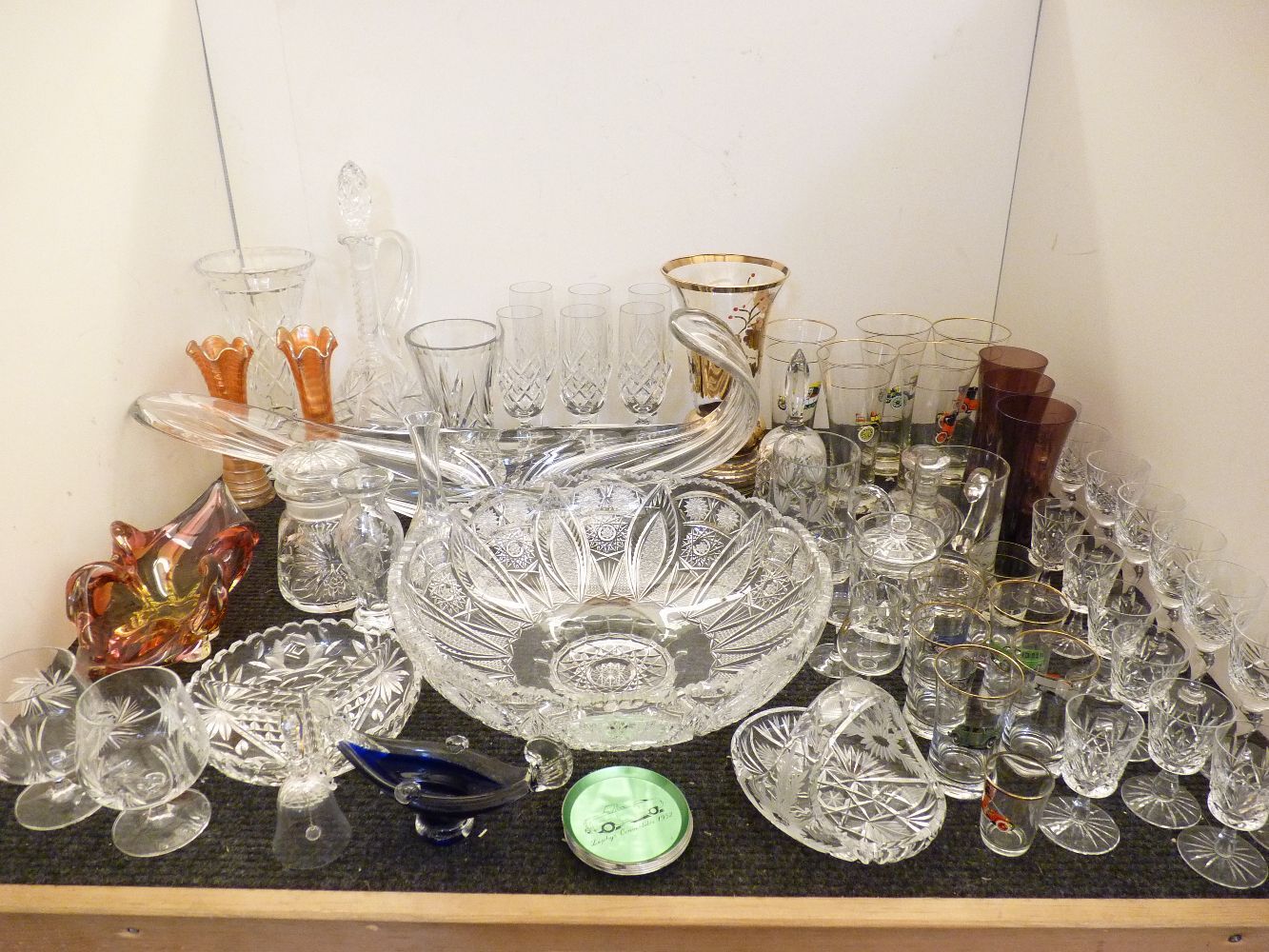 Assorted glassware, including a large cut glass bowl, glasses with classic car designs, etc