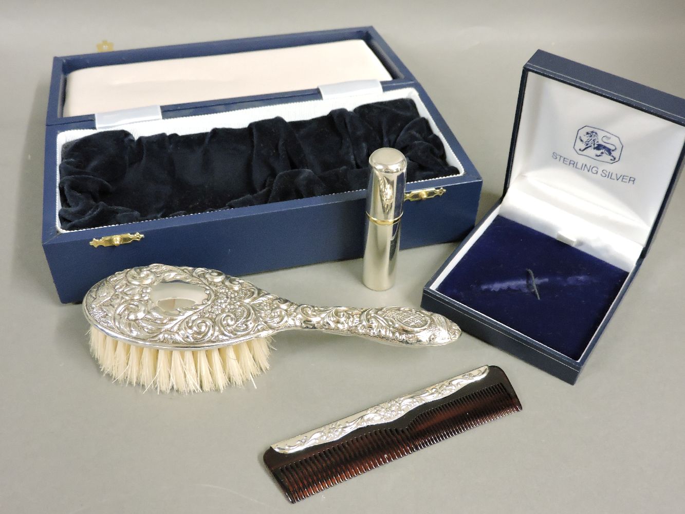 A modern cased silver mounted child's hairbrush, Birmingham 2005, 17cm long, and a modern cased