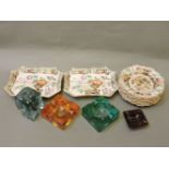 Twelve early 19th century stoneware floral decorated plates, a glass dump, and three glass ashtrays
