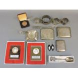 Silver items, three cigarette cases, three napkin rings, coins, sterling bracelet, cased silver