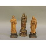 An antique carved softwood figure of the Virgin Mary and Christ Child, 10cm high, and two other