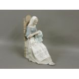 A Lladro figure, of a girl seated in a chair sewing a tapestry, 28cm