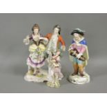 A Vienna porcelain figure, of a hurdy gurdy player, 17cm, and two other figure groups