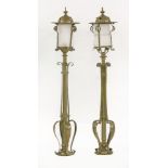 A pair of Scottish Arts & Crafts brass newel post lamps,with domed tops, frosted glass shades and