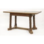 An Arts and Crafts oak centre table,the rectangular top on twist turned supports linked by a floor