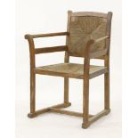 An Arts & Crafts oak armchair,with a rush seat and back