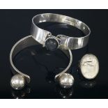 A Finnish sterling silver labradorite bangle,by Kaunis Koru, Helsinki, a circular cabochon