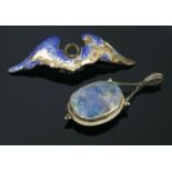 An Arts and Crafts black opal pendant,with an oval black opal matrix cabochon, rub set to a plain