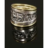 A silver and gold tapered band ring,by Patricia Ann Fruttauro, with a deeply textured central silver
