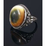 An Arts and Crafts silver operculum ring,with applied leaf and bead shoulders to a double wire