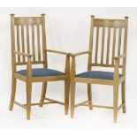 A pair of Arts & Crafts oak armchairs,with inlaid chevron banding, each with drop-in seats (2)