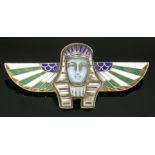 A German, Egyptian Revival, silver gilt brooch,with a death mask to the centre, champlevé enamel