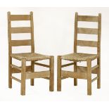 A pair of limed oak Letchworth chairs,c.1910, designed by Sir Ambrose Heal and manufactured by