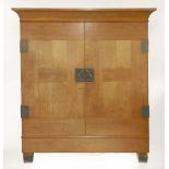 A German Secessionist ash wardrobe,with large brass lock plates with shaped handles and hinges,