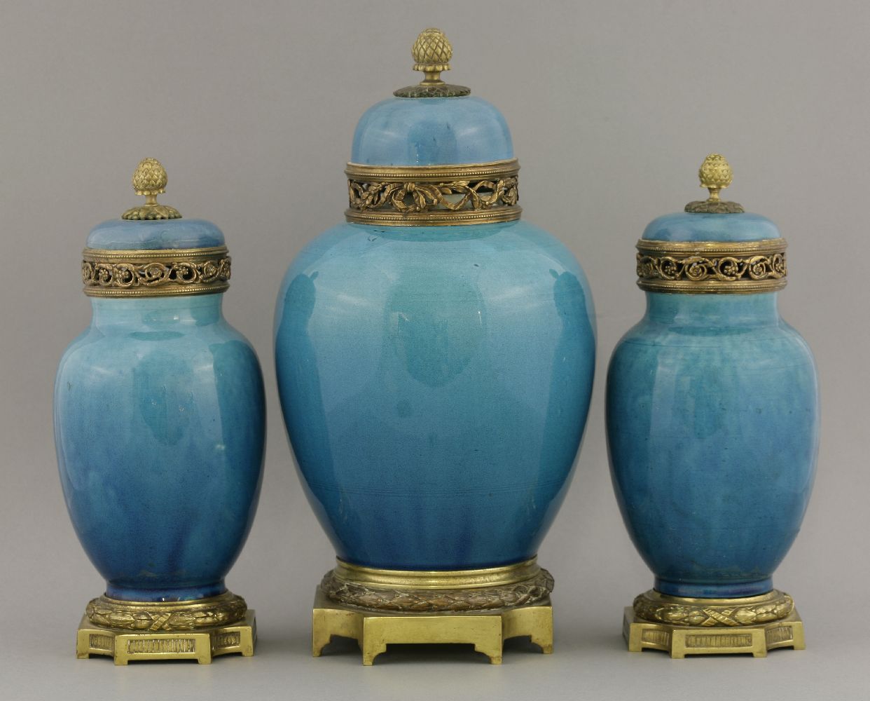 A garniture of three Vases, c.1900, the ovoid body under a turquoise glaze with gilt metal mounts,