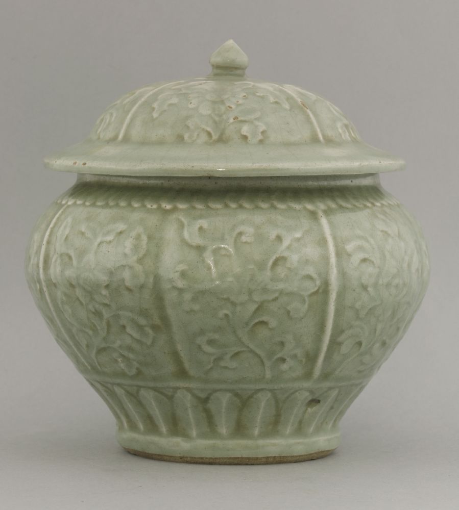 A celadon Guan and Cover,16th century or later, the lobed body moulded with floral sprigs beneath