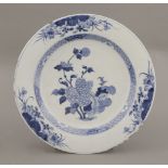 An underglaze blue Plate, mid 18th century, the centre with peony within a diaper border, the rim