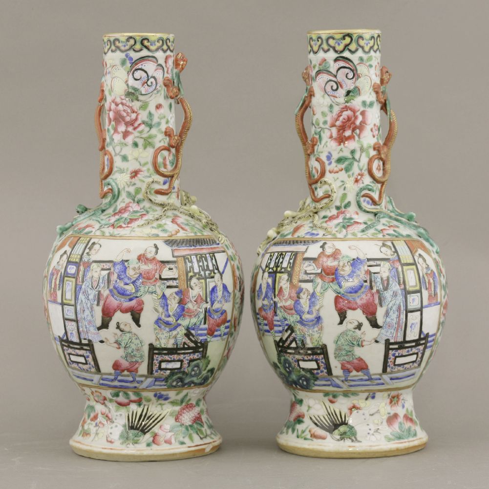 A pair of famille rose Vases,c.1880, typically enamelled with panels of a figure feasting with