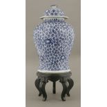 A large baluster blue and white Vase and Cover,c.1800, painted with asters growing from thread stems