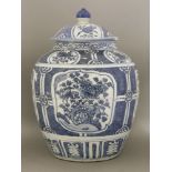 A blue and white Potiche and Cover,c.1600, painted with panels of lotus and peony reserved on a