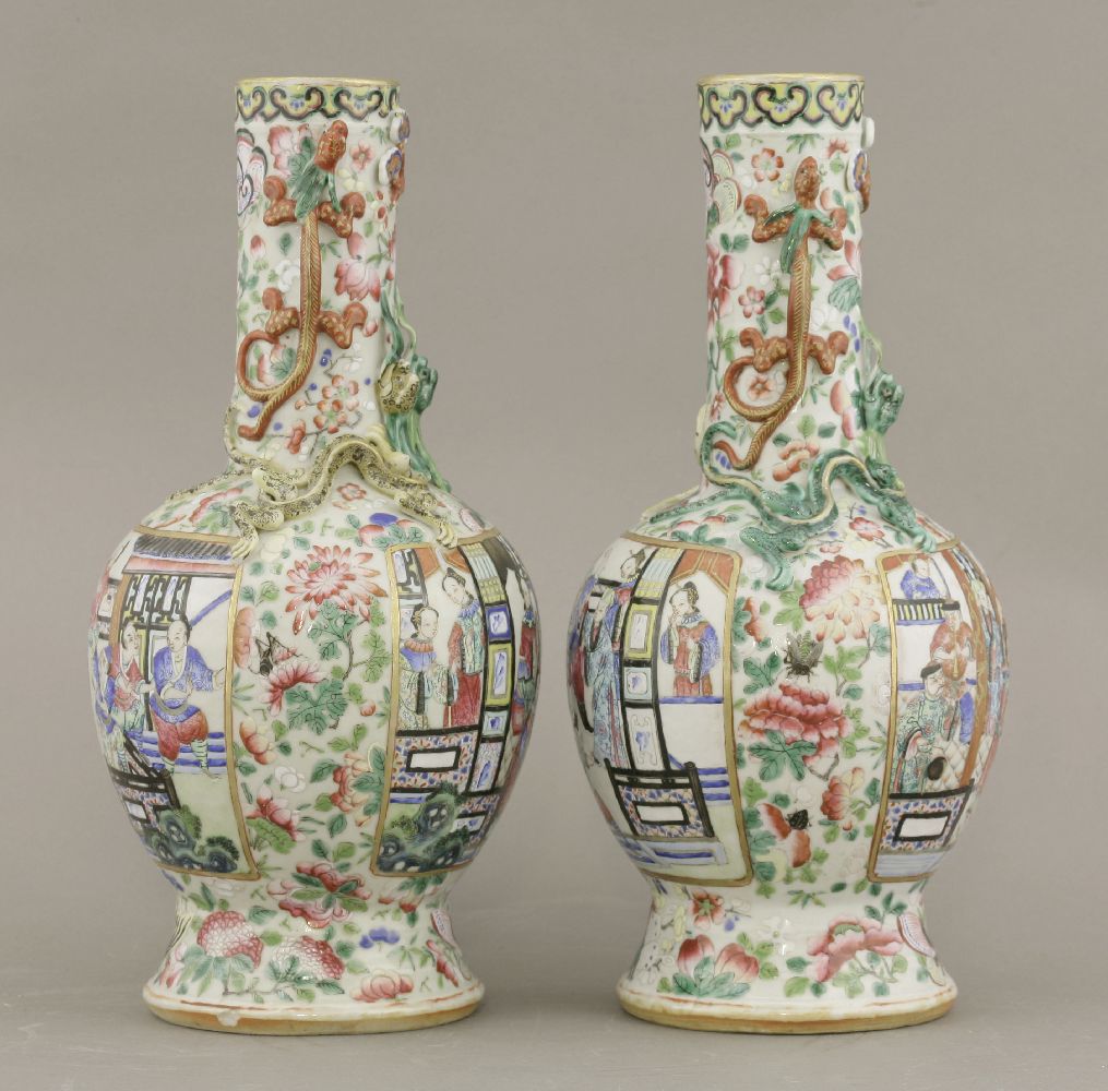 A pair of famille rose Vases,c.1880, typically enamelled with panels of a figure feasting with - Image 2 of 4