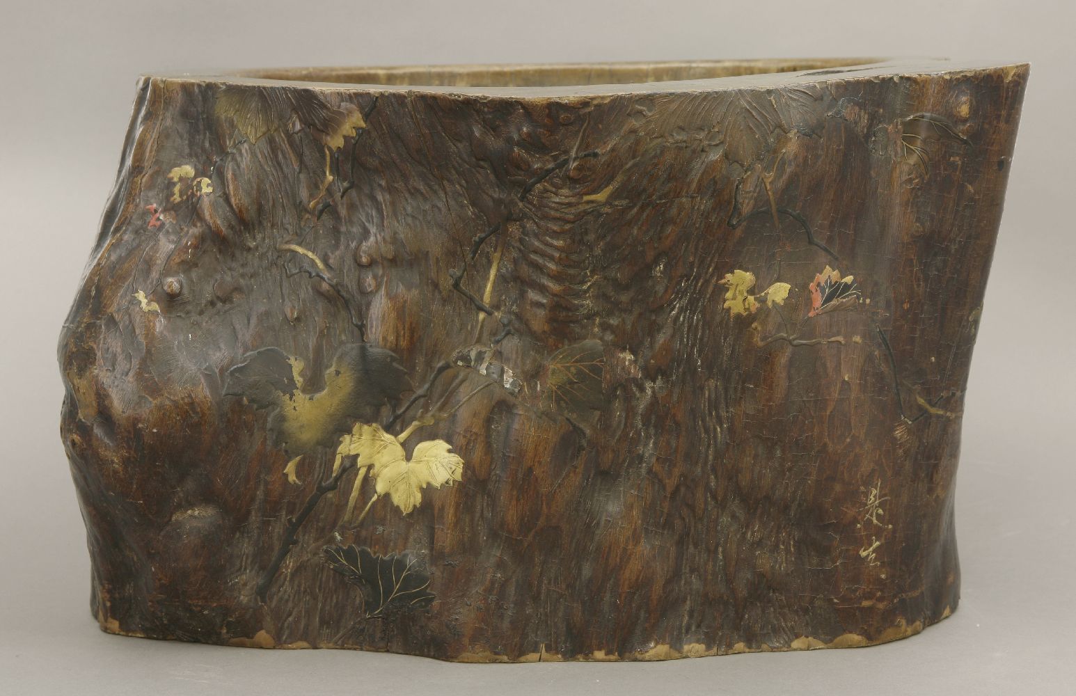 A lacquered wood Hibachi,Meiji period, decorated with leaves and branches in relief in gilt, red and