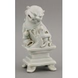 A rare qingbai Buddhist Lion and Cub,Yuan dynasty (1279-1368), the smiling beast looking down at its