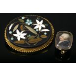 A Victorian pietra dura gold plaque brooch,with hardstone samples of lilies and forget-me-nots to