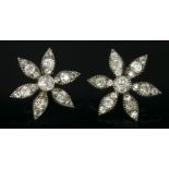 A pair of early Victorian diamond set flower heads, c.1850,later converted to earrings.  Each