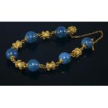 An early Victorian gold and stained jasper bead bracelet,with six 13mm stained jasper beads, all