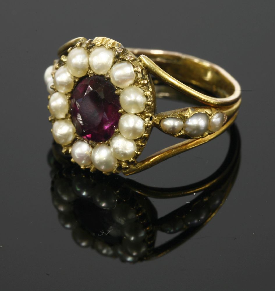 A Georgian gold foiled amethyst and split pearl ring,with an oval mixed cut foil back amethyst,