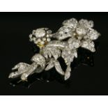 A Victorian diamond set spray brooch,flower heads with cushion cut diamonds, set in cut down collets