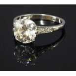 A single stone diamond ring with diamond set shoulders,with an old European cut diamond, estimated