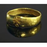 A tapered gold band ring,believed to be 4th century Roman Christian, with an impressed CHI RHO to