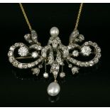 A Victorian diamond and pearl brooch/necklace, c.1880,with a scrolling centrepiece of graduated